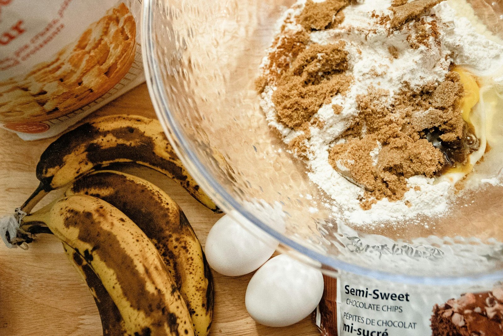Preparing to bake banana bread with flour, ripe bananas, and eggs.